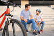 © Pixel-Shot - Father and his little son with bicycle outdoors
