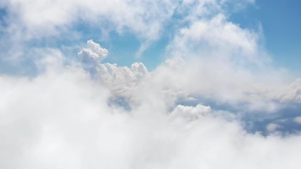 Wall Mural - flying through amazingly beautiful cloudscape. picturesque timelapse of white fluffy clouds moving s