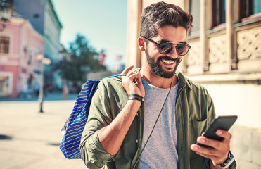 Modern young man enjoying in shopping. Consumerism, lifestyle concept