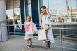 © hetmanstock2 - Beautiful girl in a summer city. Lady with shopping bags. Mother with daughter in stylish clothes