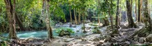 Panorama Of Bare Tree Roots And A Series Of Beautiful Short Waterfalls In The Dense Forest Of Erawan National Park In Thailand