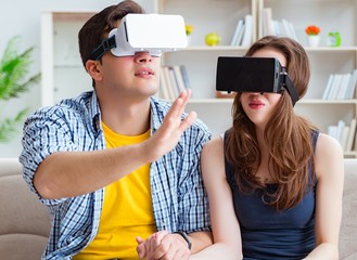 Young family playing games with virtual reality glasses