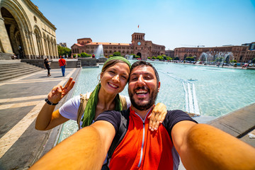 Happy tourist travelling in Armenia taking selfie photo in Yerevan city.