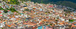 Cityscape photograph of the historic city center of Quito with its colonial architecture and colors in panoramic format.