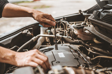 Wall Mural - Auto mechanic working in garage Technician Hands of car mechanic working in auto repair Service and Maintenance car check.