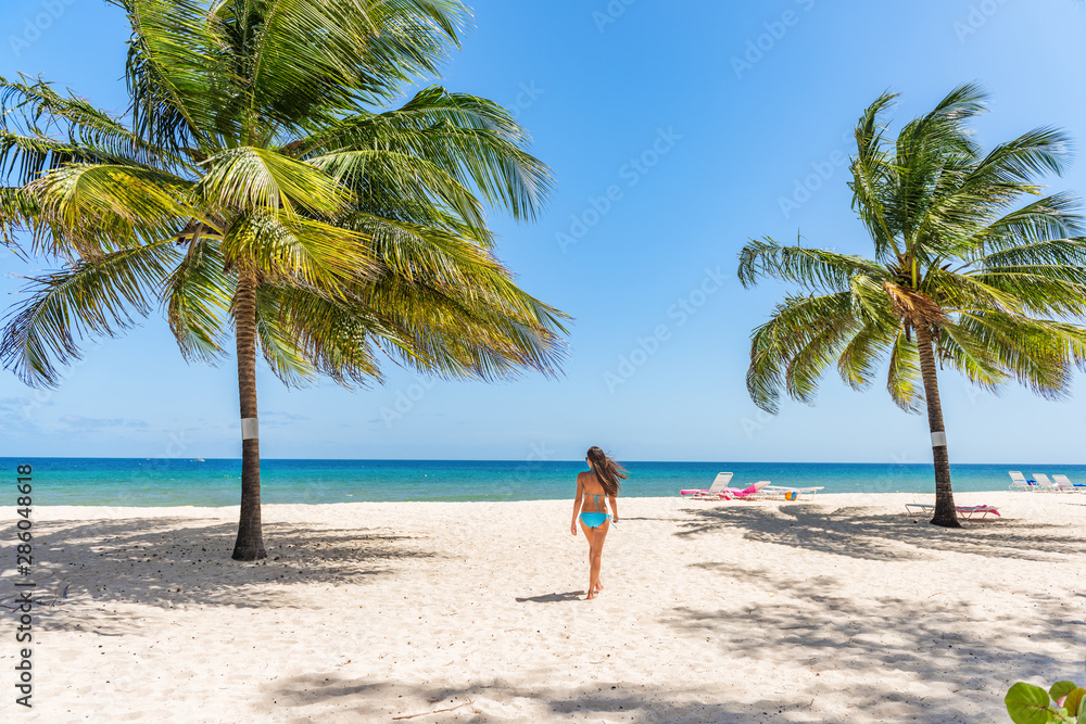 Beach tropical vacation in Barbados Caribbean travel holiday, Dover beach woman walkingin the sun in swimsuit happy on beach, Summer destination. . - obrazy, fototapety, plakaty 