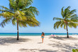 Beach tropical vacation in Barbados Caribbean travel holiday, Dover beach woman walkingin the sun in swimsuit happy on beach, Summer destination. .