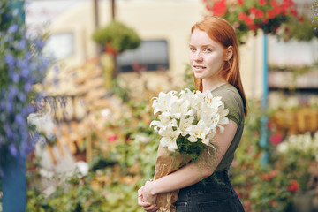 Wall Mural - Attractive girl working with flowers