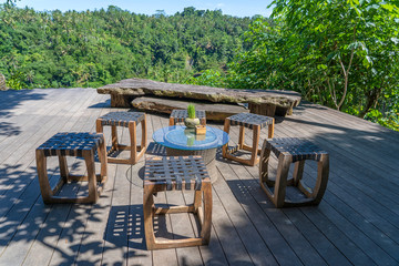 Wall Mural - Wooden table and chairs in empty tropical cafe next to rice terraces in island Bali, Indonesia