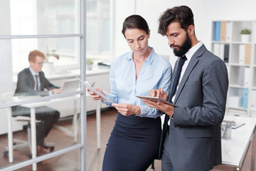 Two Colleagues Working in Office