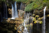 Fototapeta Kwiaty - beautiful waterfall photo background, rocky field