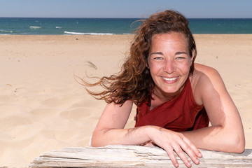 Wall Mural - beautiful curly woman smile to the sun in sand beach summer