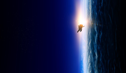 Wall Mural - spaceman and planet, human in space concept