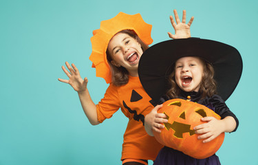 little witch and pumpkin on turquoise background