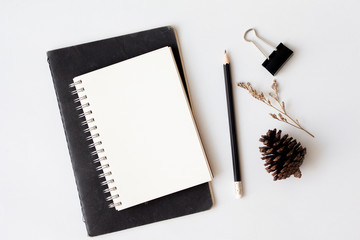 notebook and pencil on white background