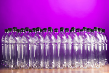 empty plastic bottles on purple background