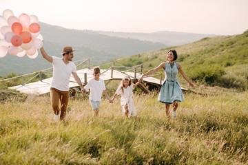 Wall Mural - Happy family in nature. Happy family: mother, father, children son and daughter. life is made of little things.