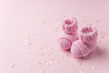 Pair of small baby socks on pink background with copy space for your warm message, baby shower, first newborn party background, copy space, cute minimal postcard