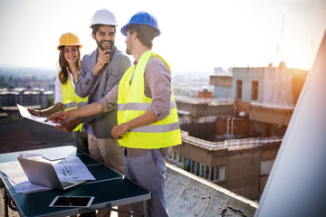 Architects, business manager and engineer meeting project at building site