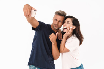 Canvas Print - Cheerful couple wearing casual outfit standing isolated