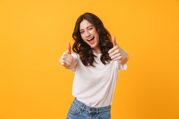 image of beautiful brunette woman wearing casual clothes winking and showing thumbs up at camera