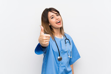 Young Nurse Woman Over White Wall With Thumbs Up Because Something Good Has Happened