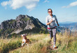 © Soloviova Liudmyla - Happy smiling female jogging by the mounting range path with her beagle dog. Canicross running healthy lifestyle concept image.