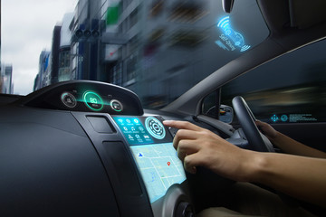 Self Driving car with futuristic graphic of GPS system driving on street in the city with Autopilot Mode. AI Technology with transportation concept.