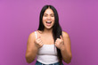 © luismolinero - Young teenager Asian girl over isolated purple background celebrating a victory