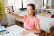© Syda Productions - people, children and technology concept - girl with smartphone taking selfie at home