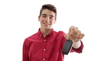 Wall Mural - young man smiling isolated with car keys or remote control