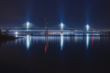 Night view of two bridges over the sea bay, Forth Road Bridge and Queensferry Crossing, Scotland, United Kingdom