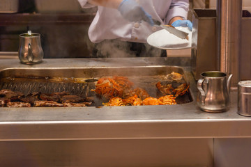 Wall Mural - Chef hand picking grilled crayfish on smoky electric stove