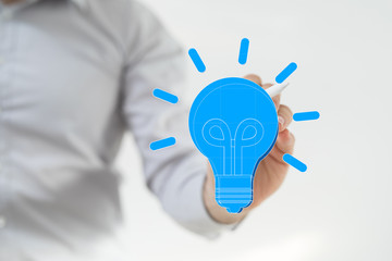  holding illuminated light bulb, idea, innovation and inspiration concept.