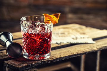 Canvas Print - Cocktail Negroni on a old  wooden board. Drink with gin, campari martini rosso and orange