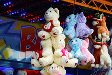 Hanging Teddy Bears And Cuddly Animal Prizes In A Stall On A Funfair. Plush Toy Animals At The Fairground.