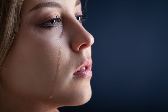 tears on woman face, beauty girl cry on black background