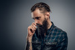 © Fxquadro - Bearded skinny man with tattooes feels dispair and sorrow while thinking about life.