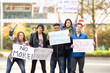 © Mat Hayward - Group of five people protesting outside with signs