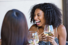 Young Woman Laughing And Drinking Wine