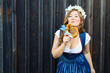 © karepa - Young woman with pretzel on a wood background .Oktoberfest concept