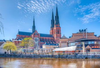 Wall Mural - Uppsala cathedral reflecting on river Fyris in Sweden