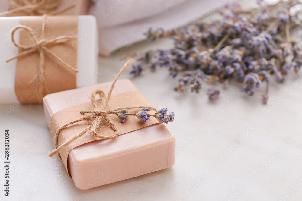 Soap bars and lavender on light background