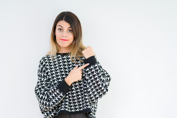 Canvas Print - Young woman wearing casual sweater over isolated background In hurry pointing to watch time, impatience, upset and angry for deadline delay