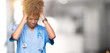 © Krakenimages.com - Young african american doctor woman over isolated background suffering from headache desperate and stressed because pain and migraine. Hands on head.