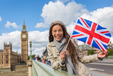 Fototapeta Londyn - London Big Ben Westminster travel tourist woman showing United Kingdom UK flag. Europe vacation destination Asian girl holding Great Britain british flag Union Jack sign.