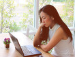 © Phuttharak - Asian woman sit with computer laptop look worried and stressed.