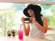 © Phuttharak - Asian tourist woman sitting with red drink looking and smile to her camera.
