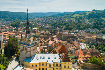 Aerial drone view of Sighisoara old city and clock tower, Romania