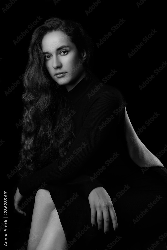 Portrait of a beautiful young woman with elegant long red shiny hair , hairstyle.In black elegant dress.Black and white. - obrazy, fototapety, plakaty 